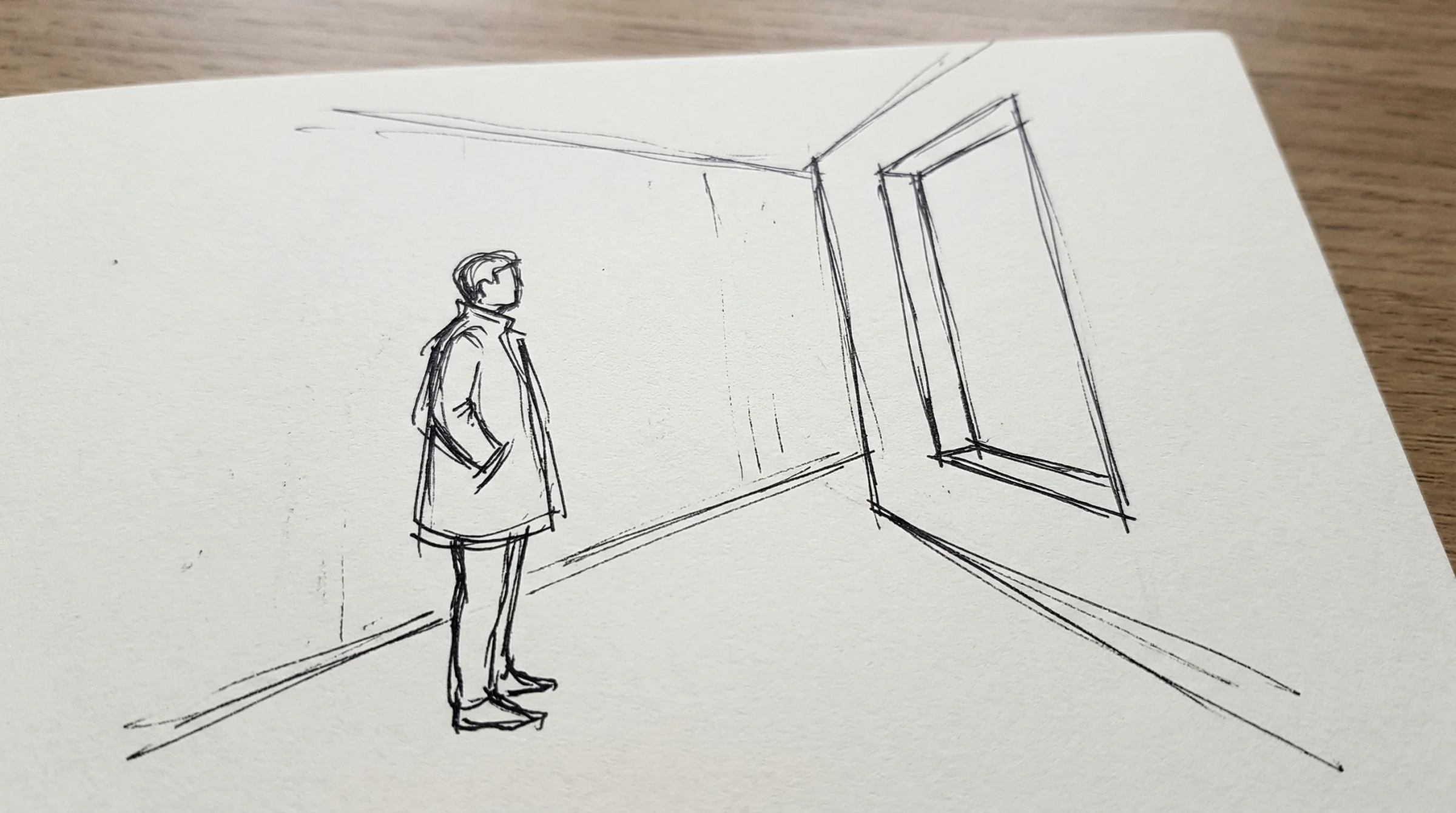 A rough pen sketch on white paper showing a figure standing in the left third of the frame facing a tall rectangular window in the right third, with a suggestion of a concrete corridor around them