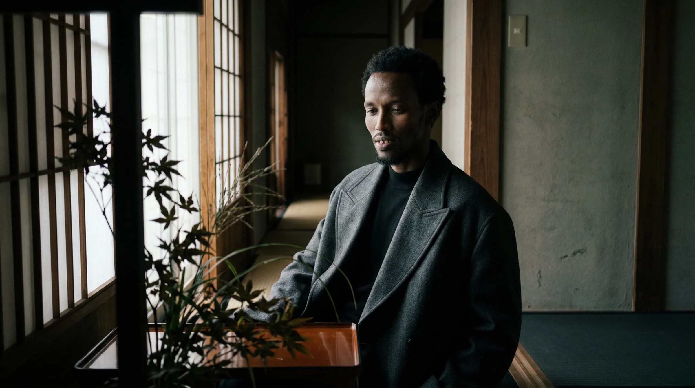 Shoot 001 — one of the first ryokan frames. Shoji screens, a maple branch in the foreground, the same man who would hold across every shot in the series. No image reference. I did not quite believe it would work, and it did.