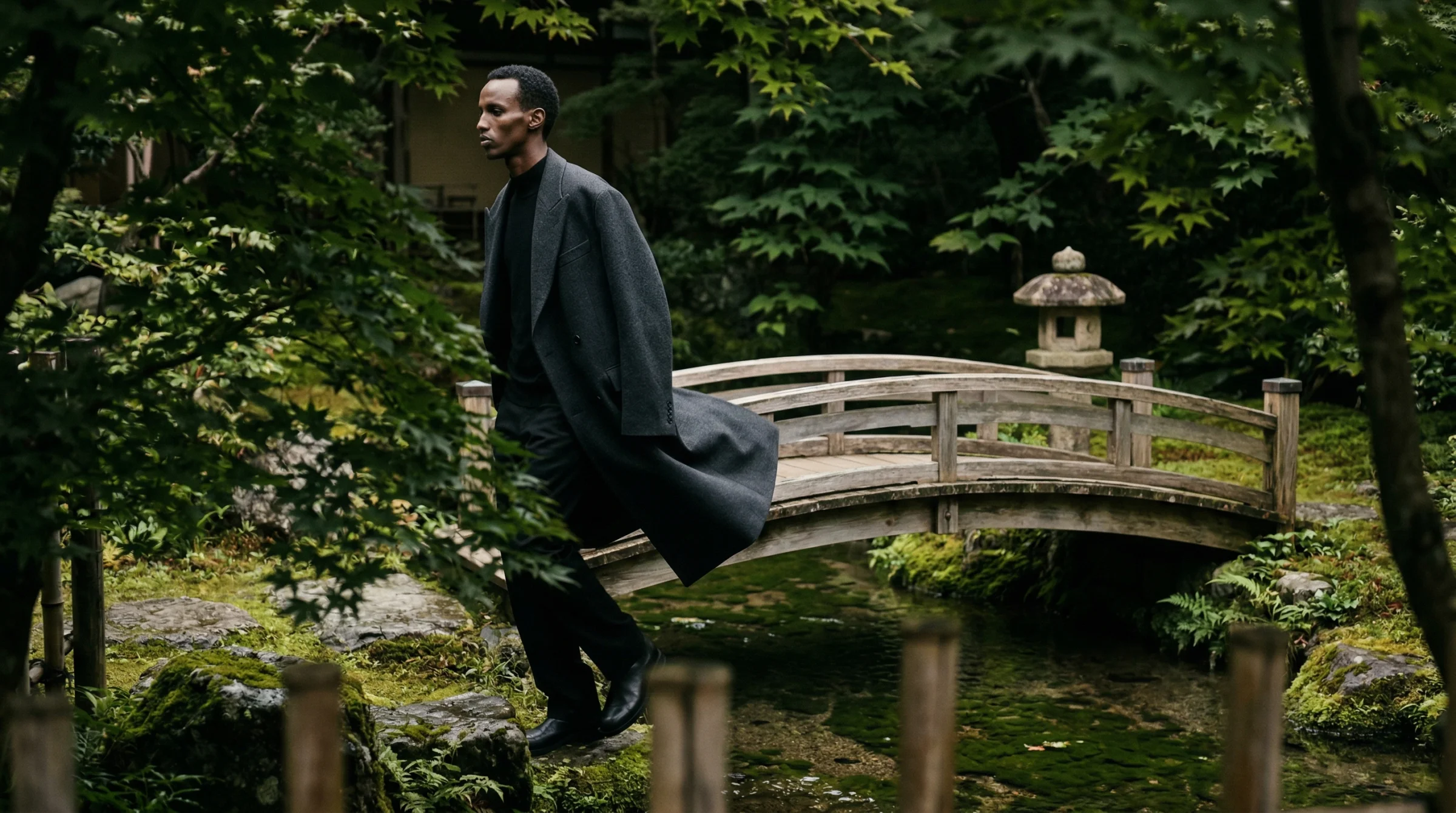 The arched bridge shot from the same shoot. A completely different environment, a different camera position, a different pose — and still the same man. This is where I stopped being suspicious.